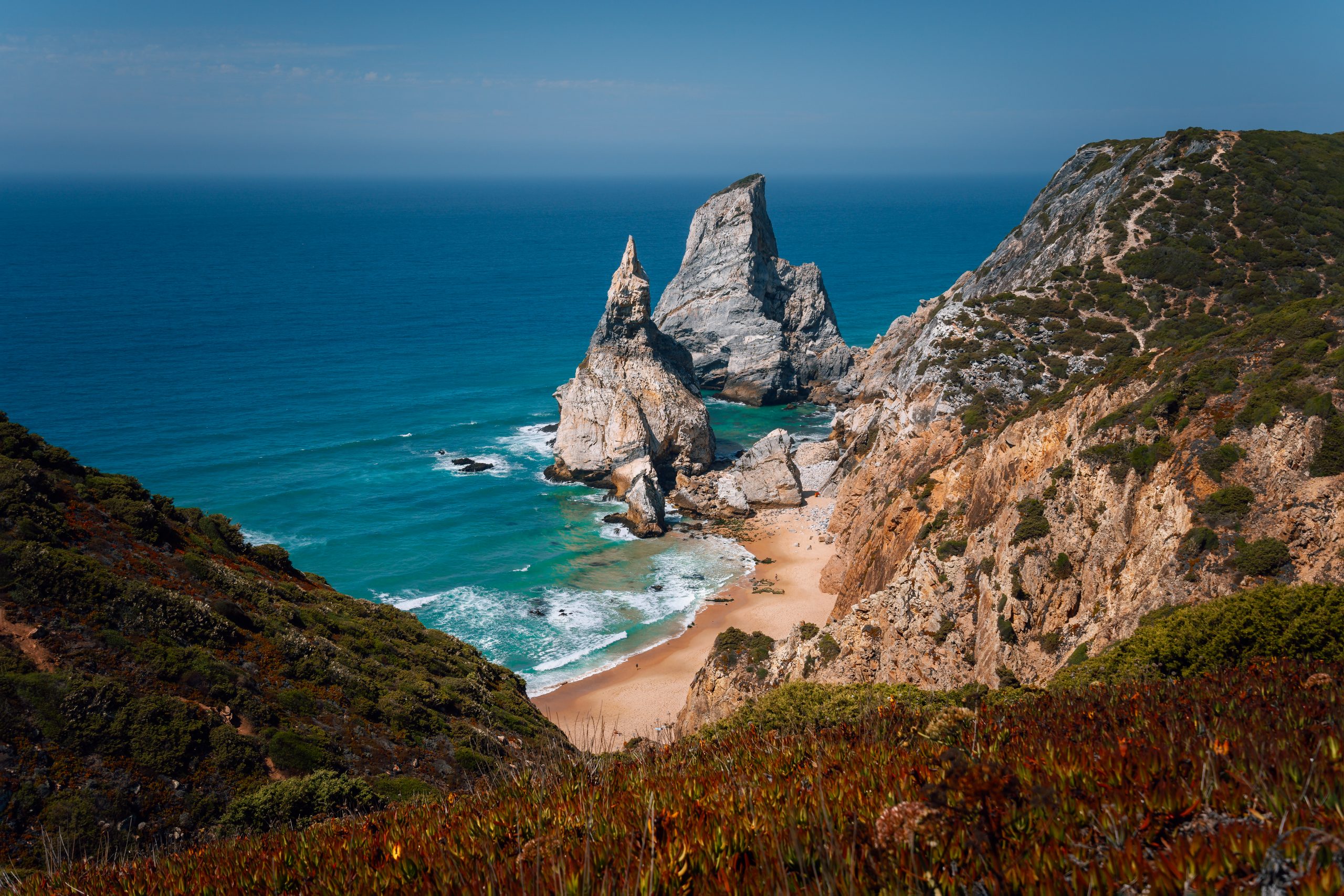 View of a hidden Praia Da Ursa Beach in sunset evening light near Cabo Da Roca on Atlantic coast, Portugal.